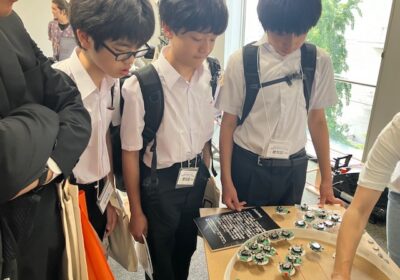 光センサーの入力により、振動モーターの動きが変わる群れロボットについての説明を中学生も真剣に聞いていました。